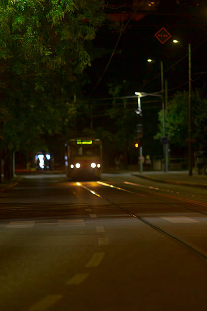 istock A bus is currently driving down a dark street during the night 2226356094