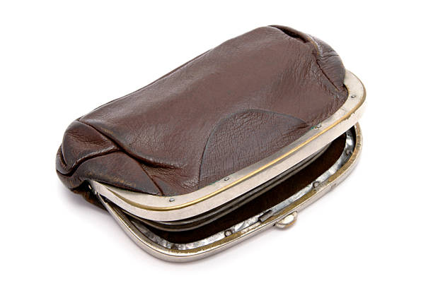 A close-up shot of a vintage brown leather coin purse with a metal frame, isolated on a white background.