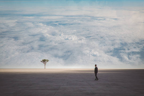 Single man standing at the end of dark corridor towards light