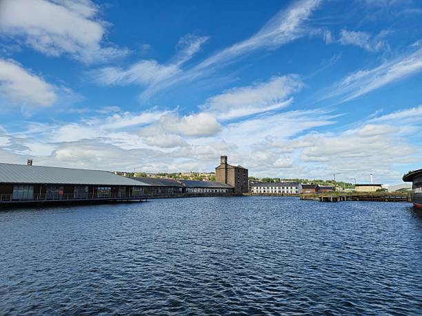 Dundee, Scotland, UK - June 22, 2024: Victoria Dock in Dundee.  On the left, City Quay shopping centre.  Old and new buildings around the dock