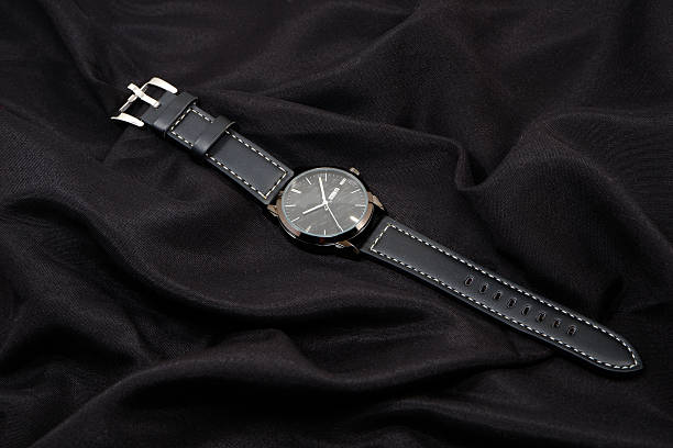 istock Black leather watch isolated on black cloth background close-up view 2226361570