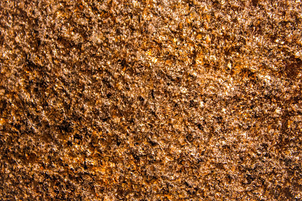 istock abstract textured stone surface with warm gold, brown and orange tones. slightly reflective sparkle effect with copy space background 2226362469