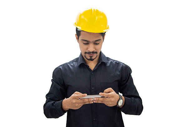 istock Young Indian Engineer Wearing a Yellow Hard Hat Using a Smartphone 2226362989