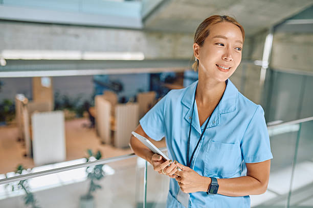istock Confident Nurse Holding Digital Tablet in Modern Hospital 2226363050
