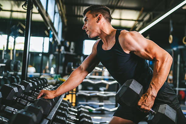 istock bodybuilder take dumbbell from the shelf and prepare for training 2226365642