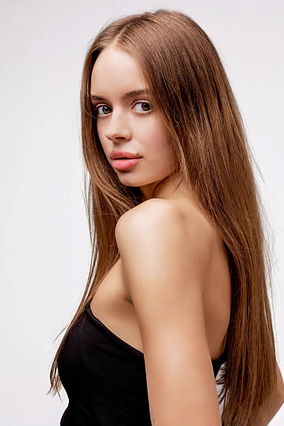 istock Model poses gracefully with long hair in studio setting, showcasing beauty and elegance during a photo session 2226367301