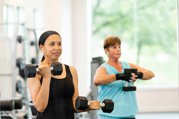 istock Two Women Exercising With Dumbbells in a Gym 2226367863