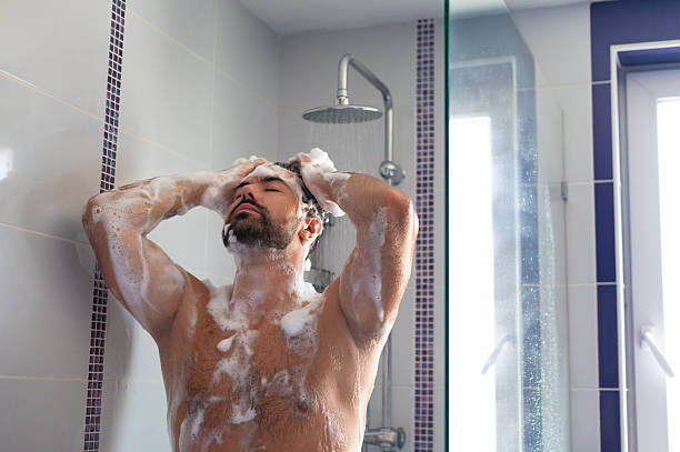 istock Young man taking a shower in the morning 2226368600