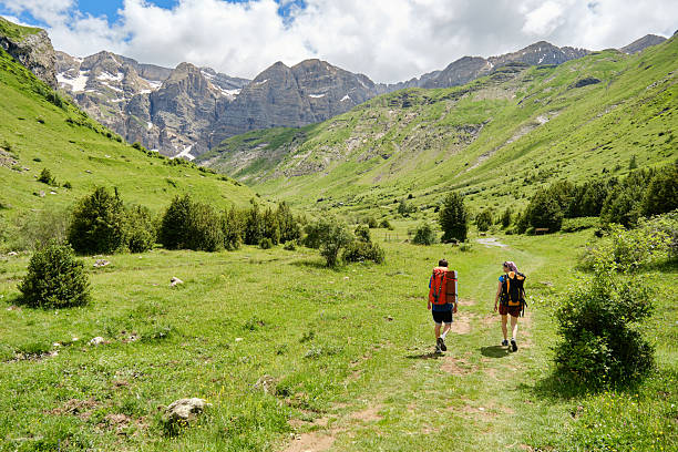 istock Hikers with backpacks hiking in a mountain valley 2226369493