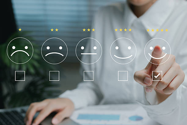 istock Customer satisfaction survey concept. Hand selecting five-star rating with emoticons representing levels of service satisfaction. 2226369528