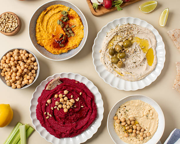 istock Different types of hummus in bowls and plates. Beetroot, pumpkin, chickpea and bean hummus. 2226370340