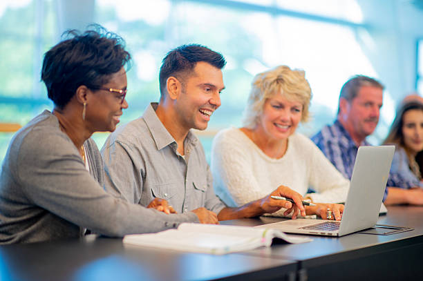 istock Colleagues Collaborating on a Business Project Around a Laptop in Bright Office 2226370895