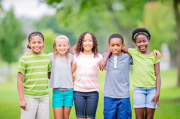 istock Group of Happy Kids Posing Together Outdoors in a Park Setting 2226373863