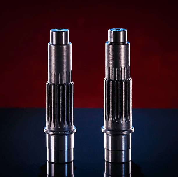 istock Two polished metal shafts stand on a dark surface 2226375843