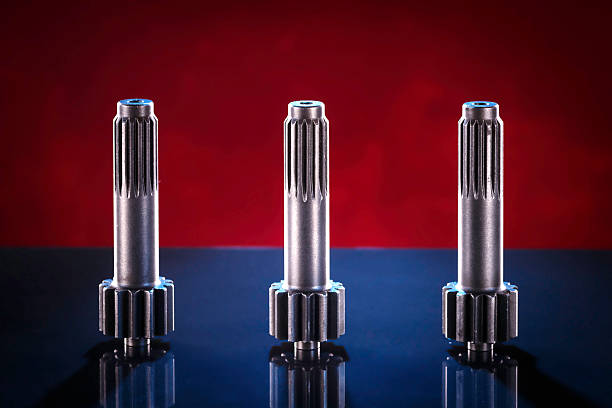 istock Three polished metal shafts stand on a dark surface 2226375854