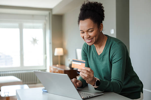 istock Woman making a credit card purchase online in a modern home environment 2226375962
