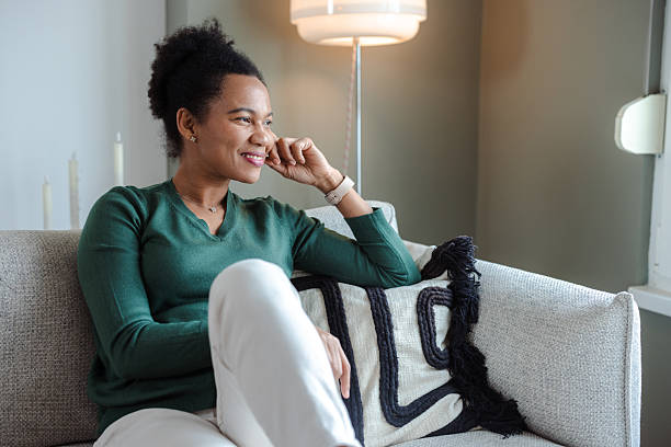 istock Relaxed woman enjoying a quiet moment at home while sitting on a couch 2226376077