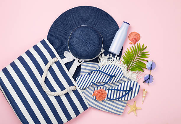 istock Blue beach bag with summer accessories on color background, top view 2226377212
