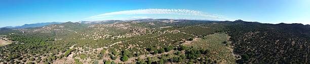 istock Breathtaking panoramic view showing vast green forest covering hills under clear blue sky 2226377629