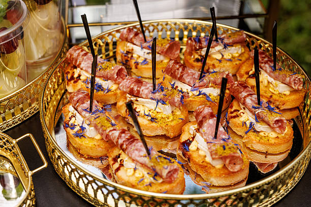 Gourmet canapes with salami, cheese, sauce and edible flowers