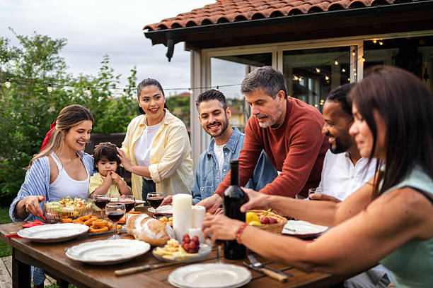 istock Diverse group gathering around sizzling grill, sharing laughter and grilled foods during outdoor summer meal in residential backyard setting 2226379625
