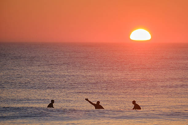 istock Surfer Pointing at Sunrise 2226380901