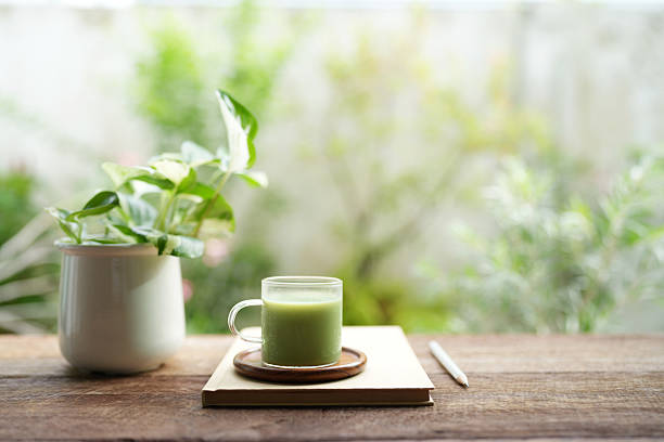 istock Matcha in a glass cup and notebook on rustic brown table 2226382370