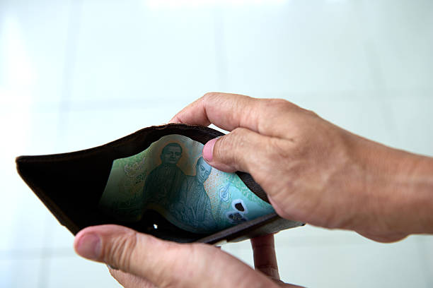 istock Hands Holding an Open Wallet With Currency Visible, Indicating Low Cash in Wallet 2226382958