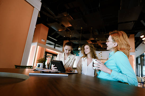istock Businesswomen collaborating in a modern office setting while discussing strategies and reviewing documents together 2226383549