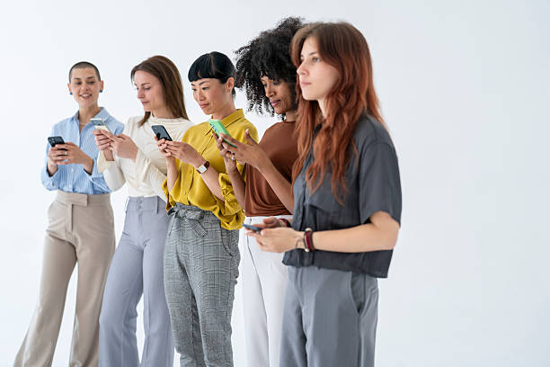 istock Five businesswomen using their smartphones in a modern office 2226383806