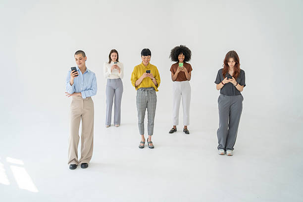 istock Five young businesswomen using their smartphones on white background 2226383818
