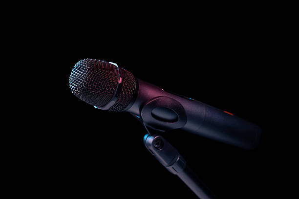 istock Close-up of microphone in studio or concert performance on stage, on black background. 2226385173
