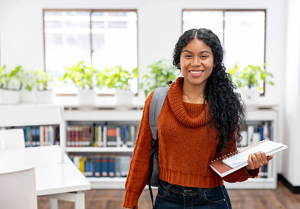 istock Happy college student smiling at the library 2226385942
