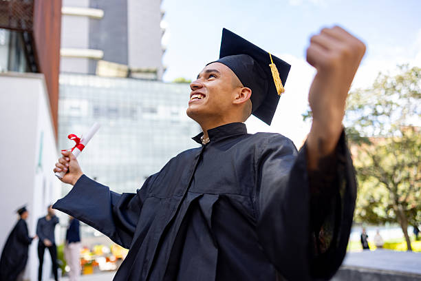 istock Happy student celebrating his graduation and holding his diploma 2226385982