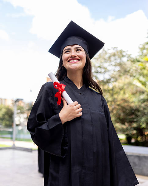 istock Happy student on her graduation day holding her diploma and smiling 2226386401