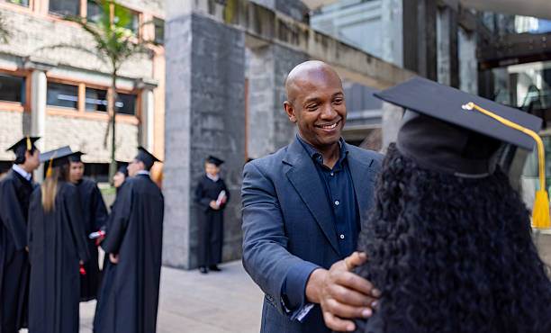 Loving father congratulating his daughter on her graduation day