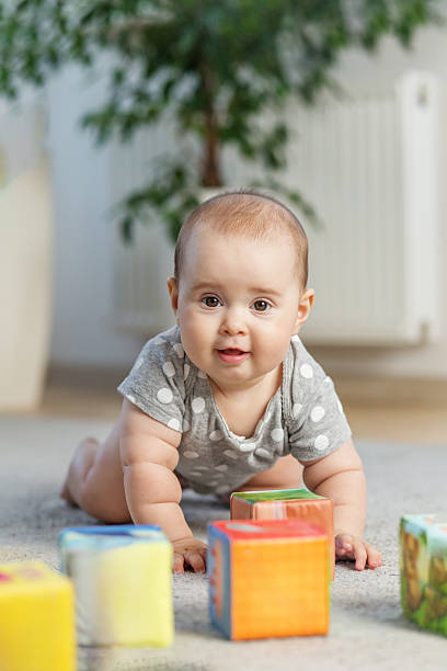 istock Cute baby crawling on floor with blocks 2226388216