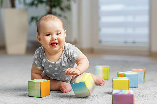 istock Smiling baby playing with colorful blocks 2226388227