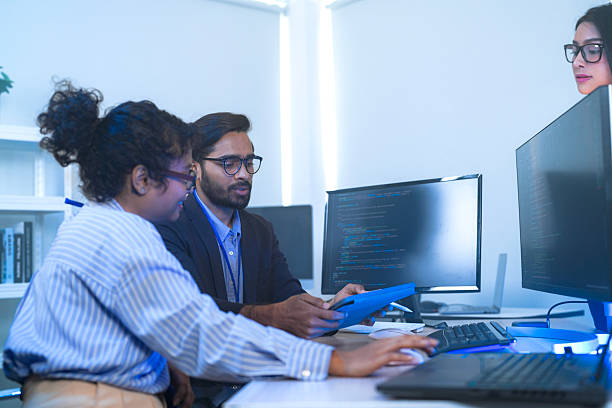istock A senior tech lead or manager mentoring a diverse team of junior developers in a modern office. Concept for project management, corporate training, and professional growth. 2226388703