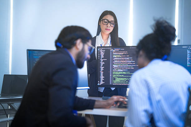 istock A senior tech lead or manager mentoring a diverse team of junior developers in a modern office. Concept for project management, corporate training, and professional growth. 2226389022