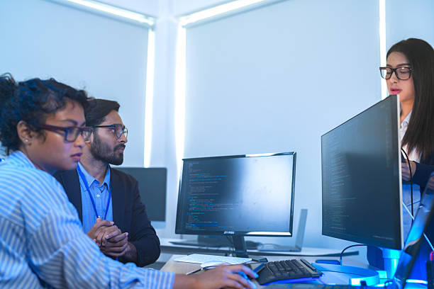istock A senior tech lead or manager mentoring a diverse team of junior developers in a modern office. Concept for project management, corporate training, and professional growth. 2226389131