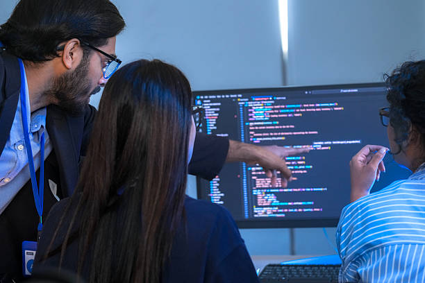 istock A senior tech lead or manager mentoring a diverse team of junior developers in a modern office. Concept for project management, corporate training, and professional growth. 2226389669
