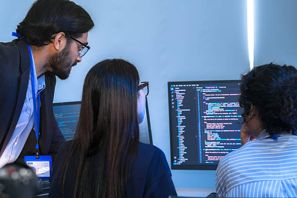 istock A senior tech lead or manager mentoring a diverse team of junior developers in a modern office. Concept for project management, corporate training, and professional growth. 2226389792