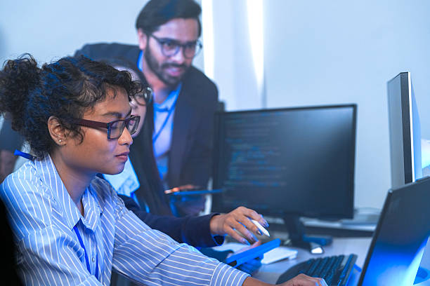 istock A senior tech lead or manager mentoring a diverse team of junior developers in a modern office. Concept for project management, corporate training, and professional growth. 2226389961
