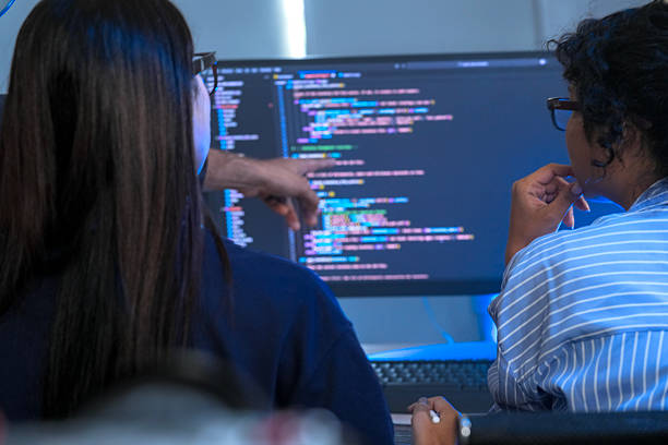 istock A senior tech lead or manager mentoring a diverse team of junior developers in a modern office. Concept for project management, corporate training, and professional growth. 2226390019