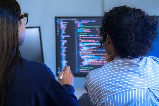 istock A senior tech lead or manager mentoring a diverse team of junior developers in a modern office. Concept for project management, corporate training, and professional growth. 2226390096