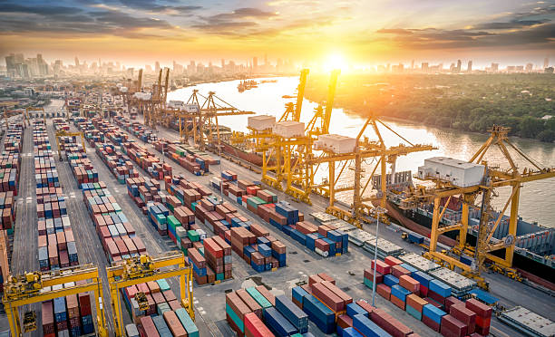istock Logistics and transportation of Container Cargo ship and Cargo plane with working crane bridge in shipyard at sunrise, logistic import export and transport industry background 2226395637