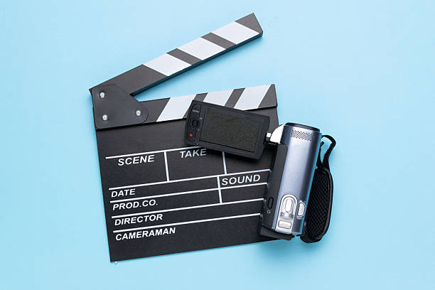 istock Film Slate and Camcorder on Light Blue Background Reflecting Modern Filmmaking 2226395961
