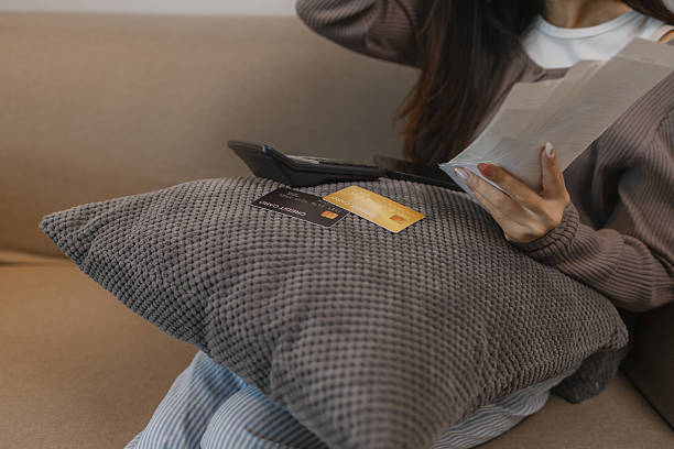 istock she feels stressed about spending on her credit cards when she sees the outstanding balance, the charges she makes form her shopping cards stress her out, debit, debit card, spend 2226397321