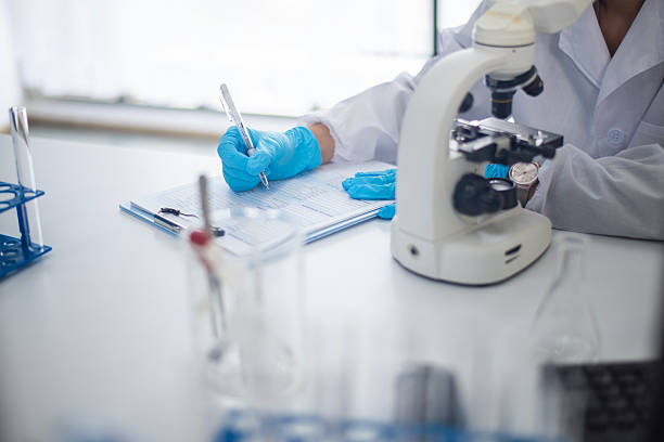 istock The scientists are documenting the experiment with a paper. 2226399900